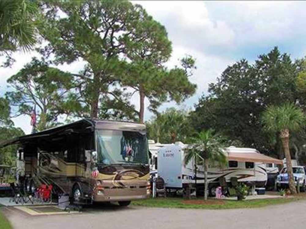 A row of RVs in spaces at VERO BEACH KAMP
