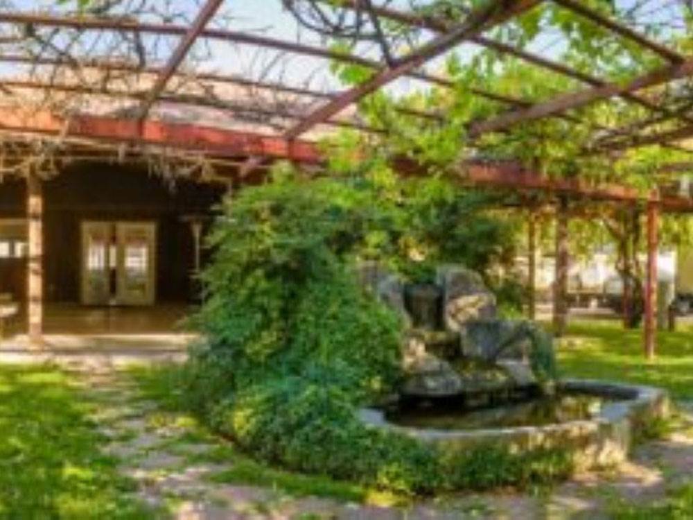 A fountain under an arbor