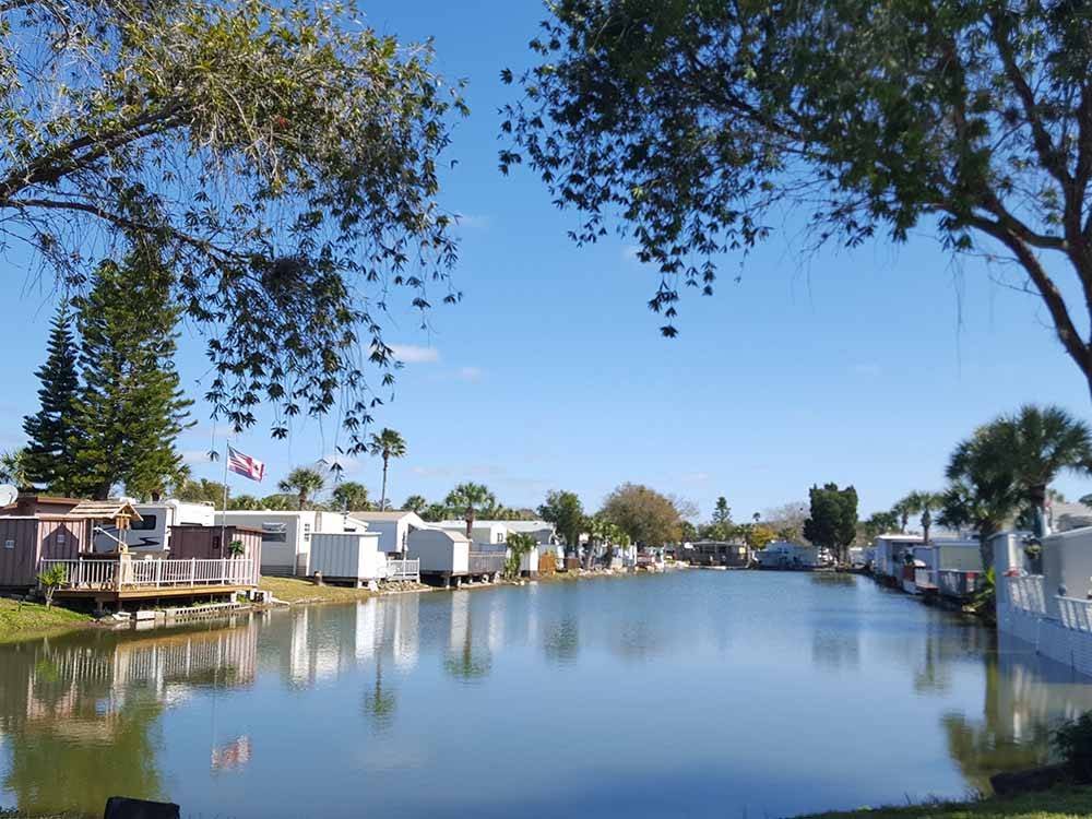 Mobile homes along the waterway at SUNDANCE LAKES RV RESORT