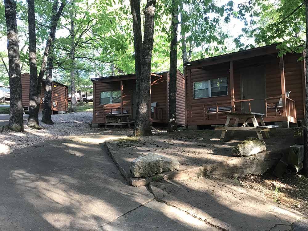 A group of rustic rental cabins at BLUE MOUNTAIN CAMPGROUND