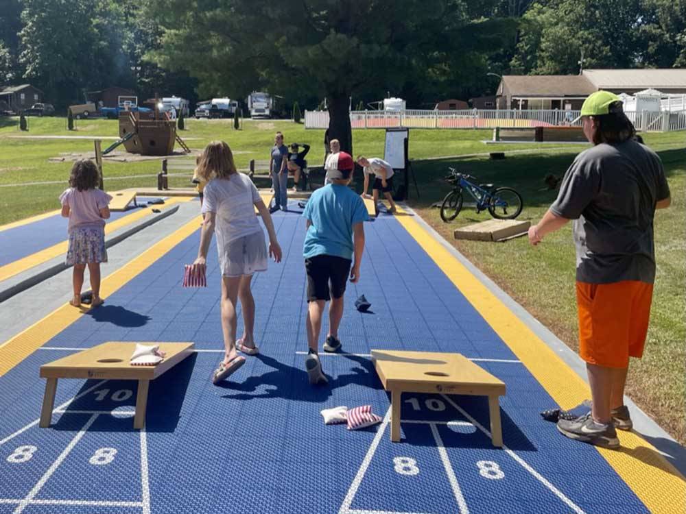 People playing cornhole at RAMBLIN' PINES FAMILY CAMPGROUND & RV PARK