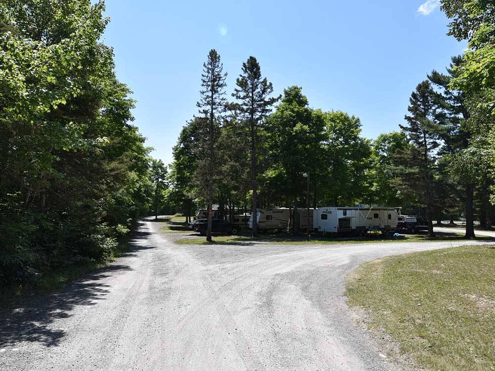 Gravel road, camp sites and trees at GLENVIEW COTTAGES & RV PARK