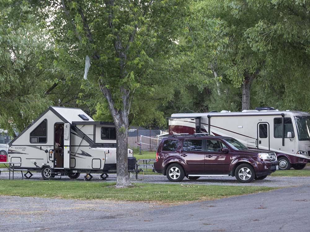 A pop up tent trailer and car parked in a site at LAKESIDE RV CAMPGROUND