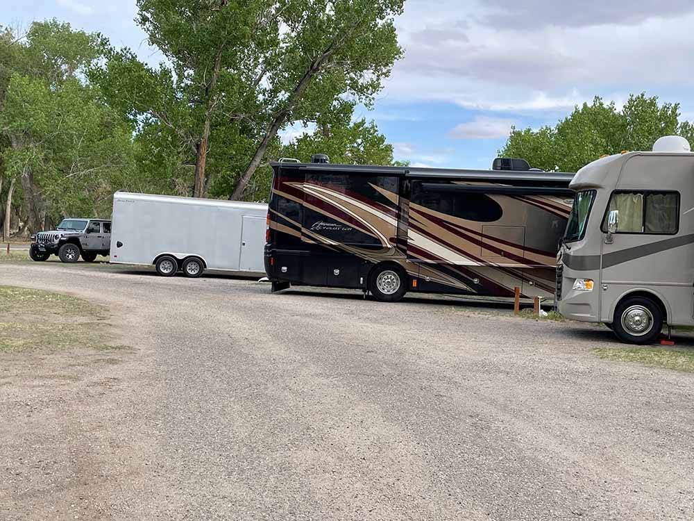 RVs parked in gravel spots at SHADY ACRES RV PARK