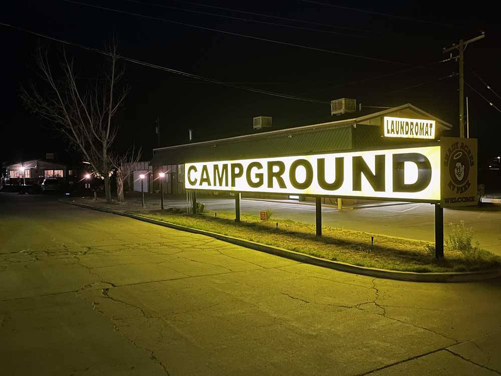 The lit up campground entrance sign at SHADY ACRES RV PARK