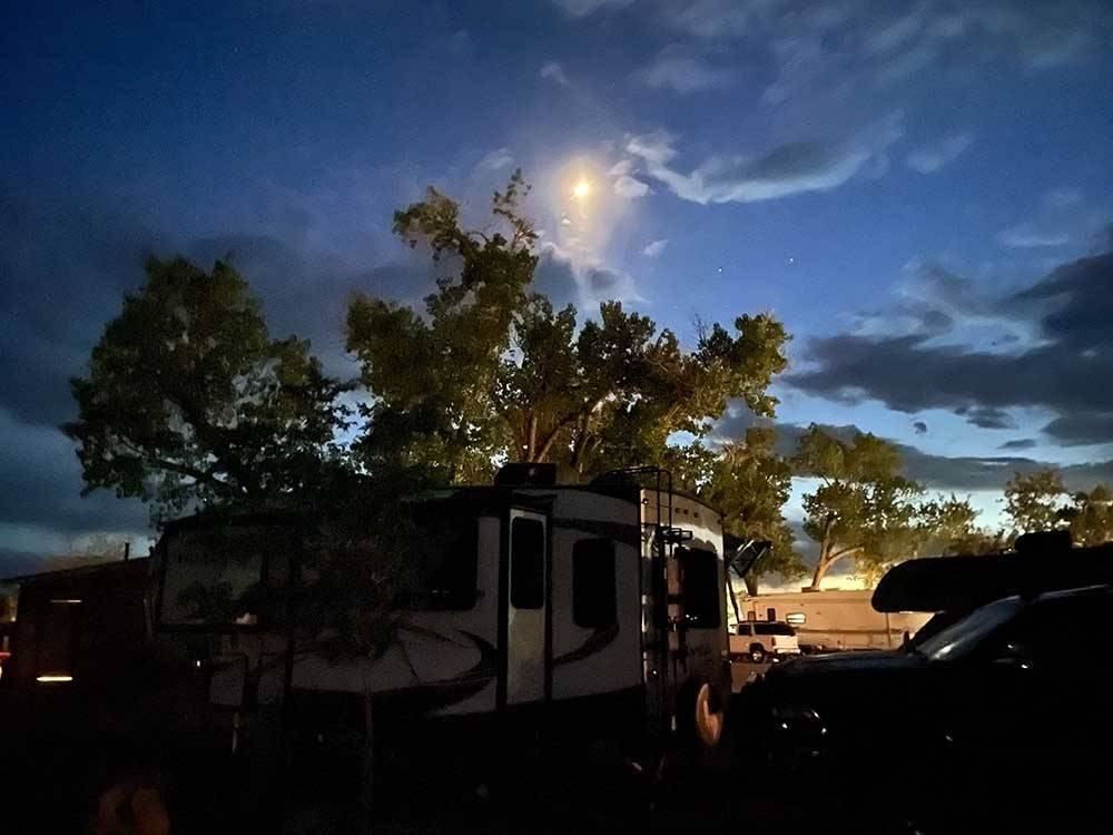 An travel trailer at dusk at SHADY ACRES RV PARK