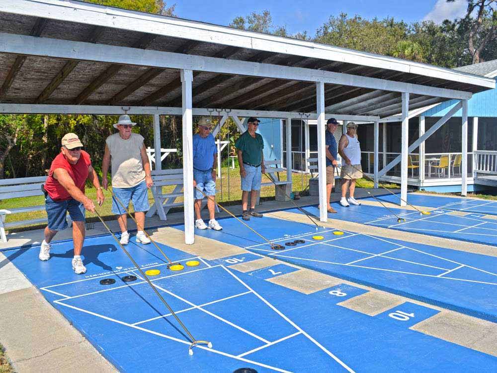 A group of men playing shuffleboard at ENCORE TERRA CEIA