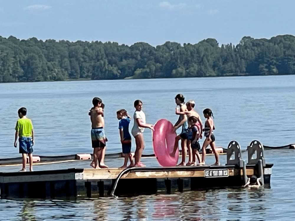 Kids standing on the dock at BEYONDER GETAWAY AT WHEELER LAKE