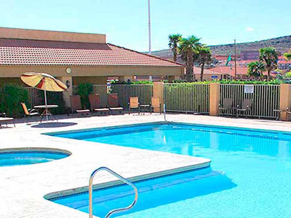 The swimming pool with lounge chairs at MCARTHUR'S TEMPLE VIEW RV RESORT
