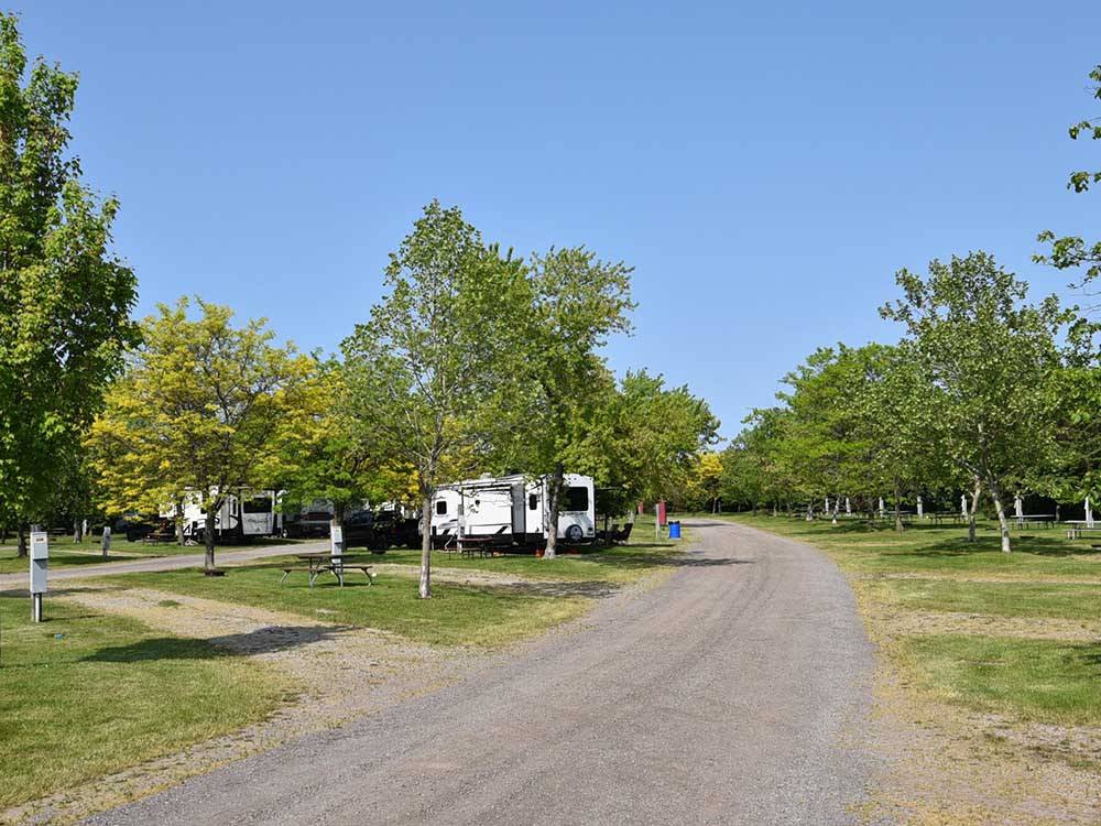 Trailers parked in gravel sites at CAMPARK RESORTS FAMILY CAMPING & RV RESORT