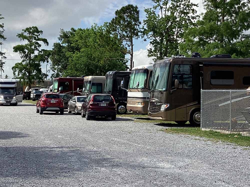 A row of gravel RV sites at JUDE TRAVEL PARK OF NEW ORLEANS