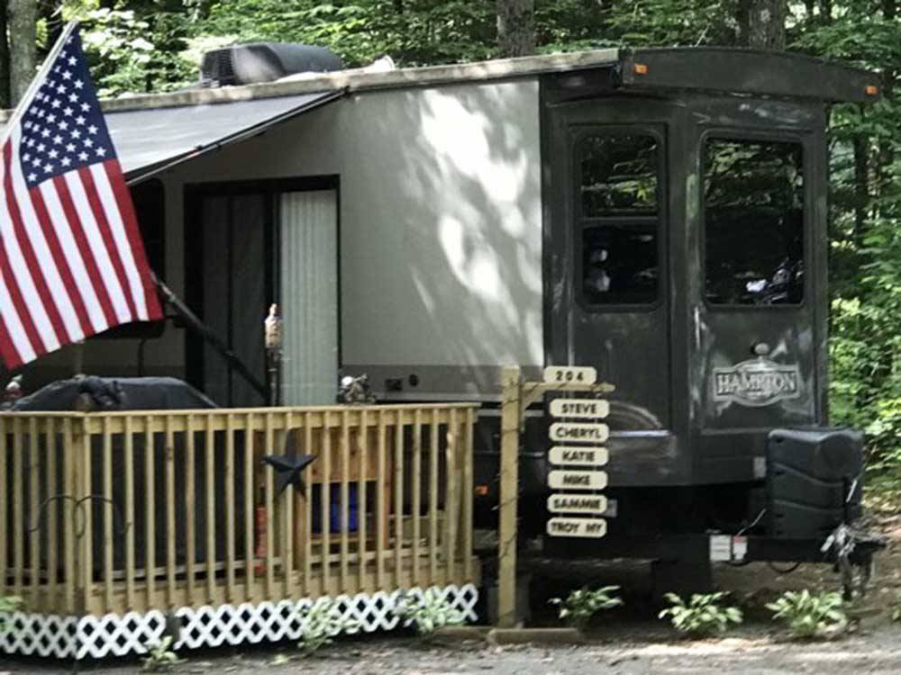 An RV with an American flag parked at SARATOGA RV PARK