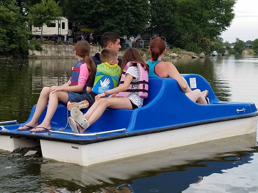 A family in a paddle boat at CAMELOT CAMPGROUND QUAD CITIES