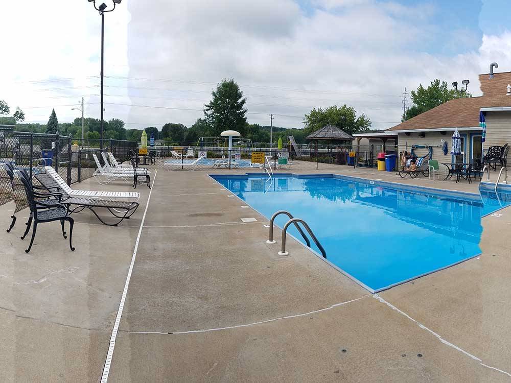 A view of the fenced in swimming pool at CAMELOT CAMPGROUND QUAD CITIES