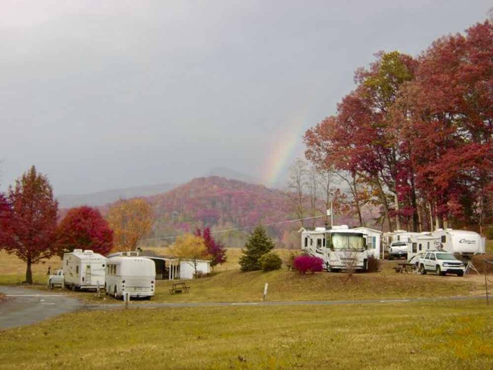 RVs parked under autumn trees at FLAMING ARROW CAMPGROUND