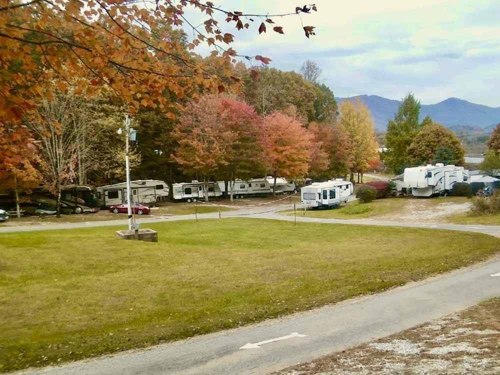 A row of trailers parked under fall cover trees at FLAMING ARROW CAMPGROUND
