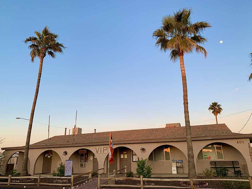 The front building with two palm trees at VIP RV RESORT & STORAGE