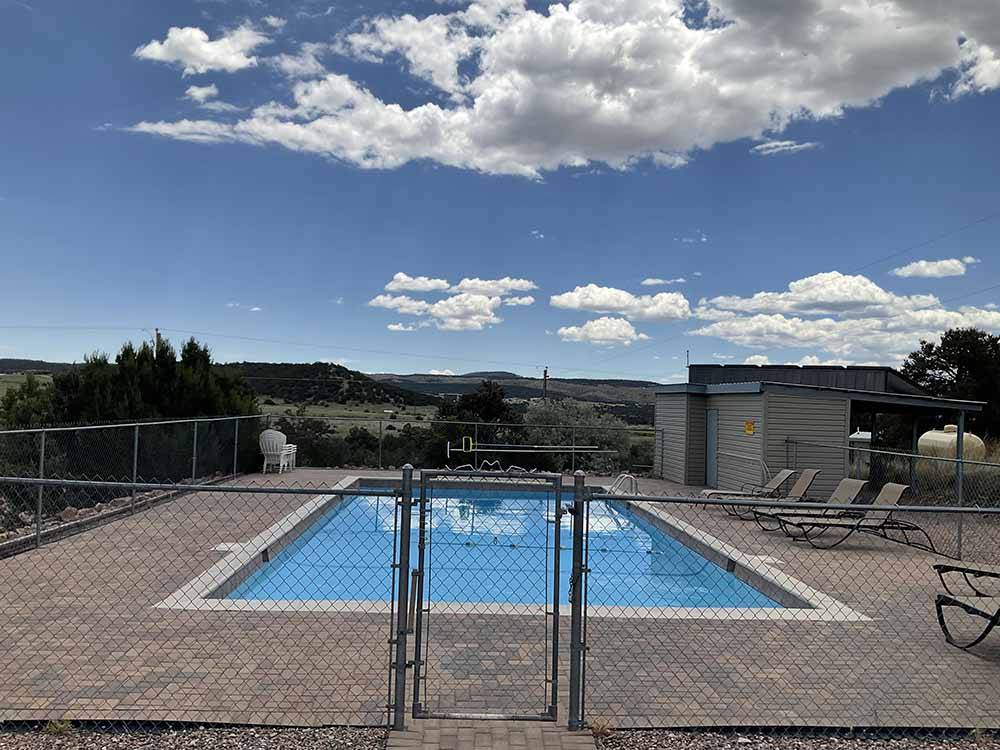 Fence surrounds a rectangular pool at ROYAL VIEW RV PARK