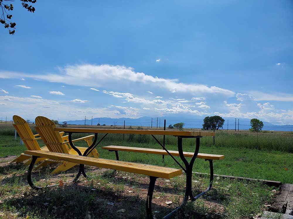 A yellow picnic bench at FALCON MEADOW RV CAMPGROUND