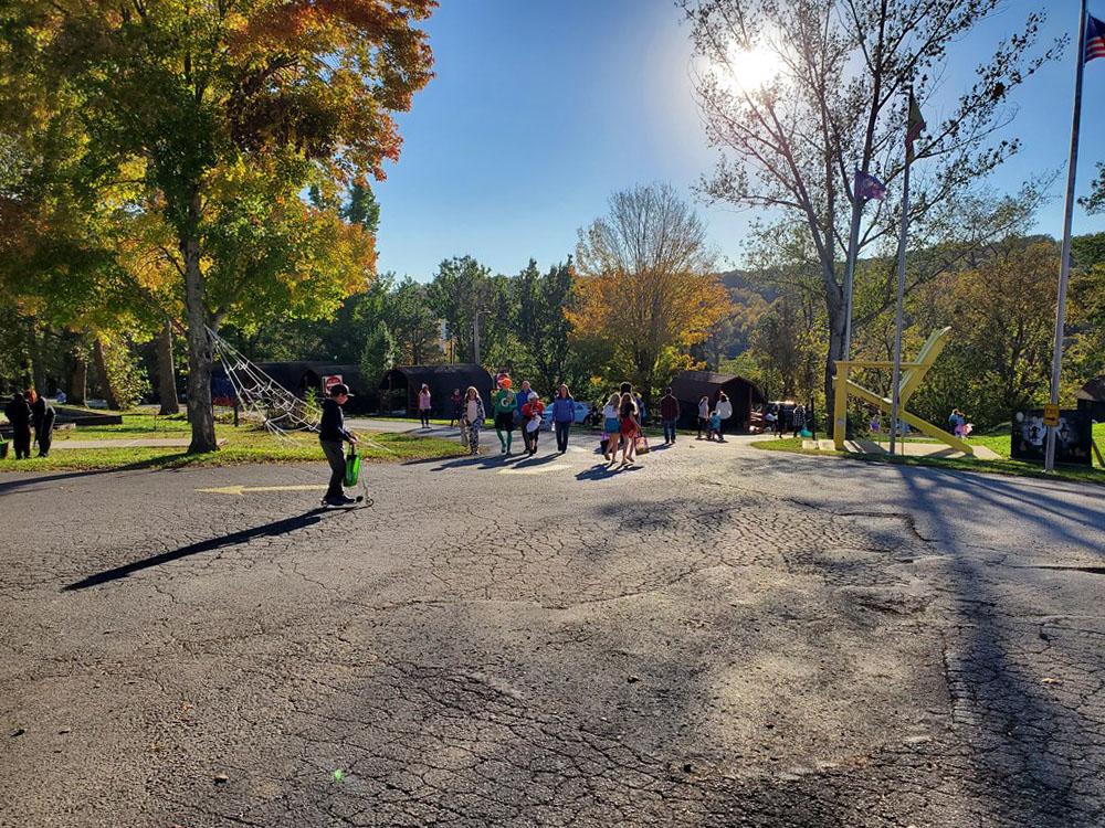 Campers walking near trees and hills at RENFRO VALLEY KOA HOLIDAY