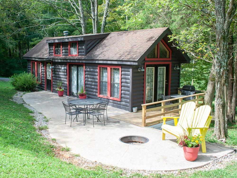 A cabin rental surrounded by trees at RENFRO VALLEY KOA HOLIDAY