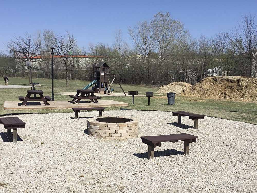 A fire pit area with seating at COWTOWN RV PARK