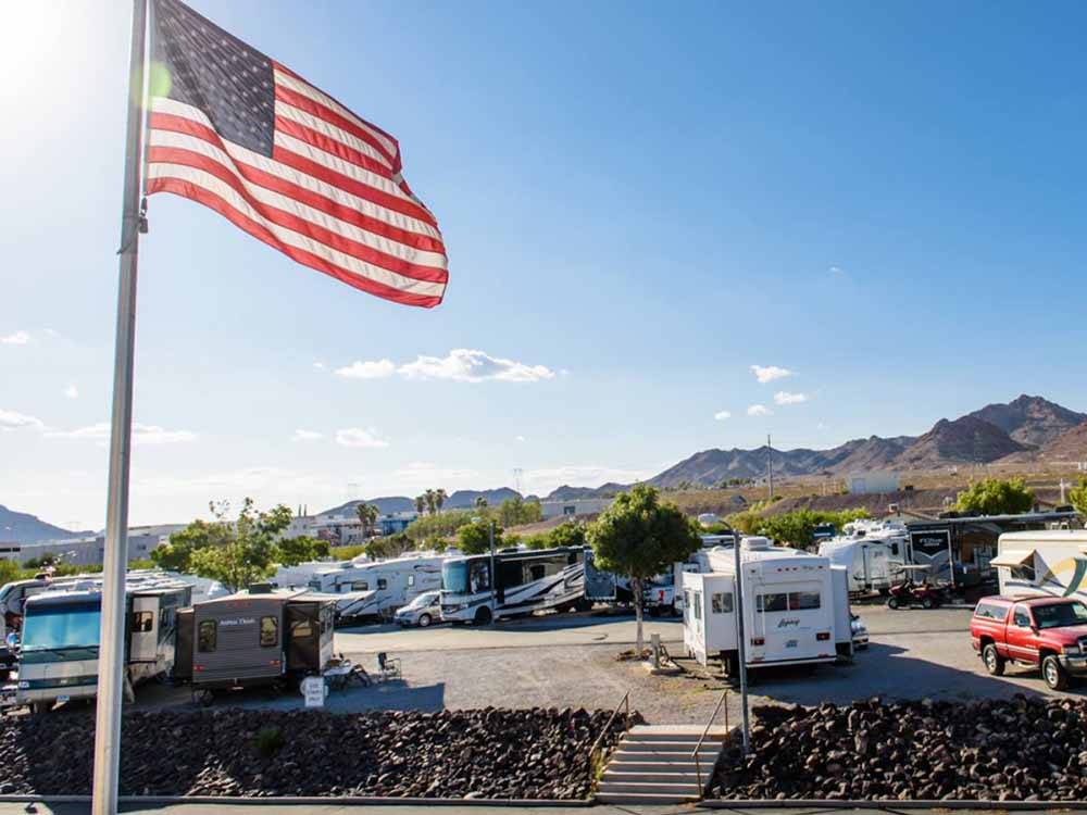 An American flag flying over the campsites at CANYON TRAIL RV PARK