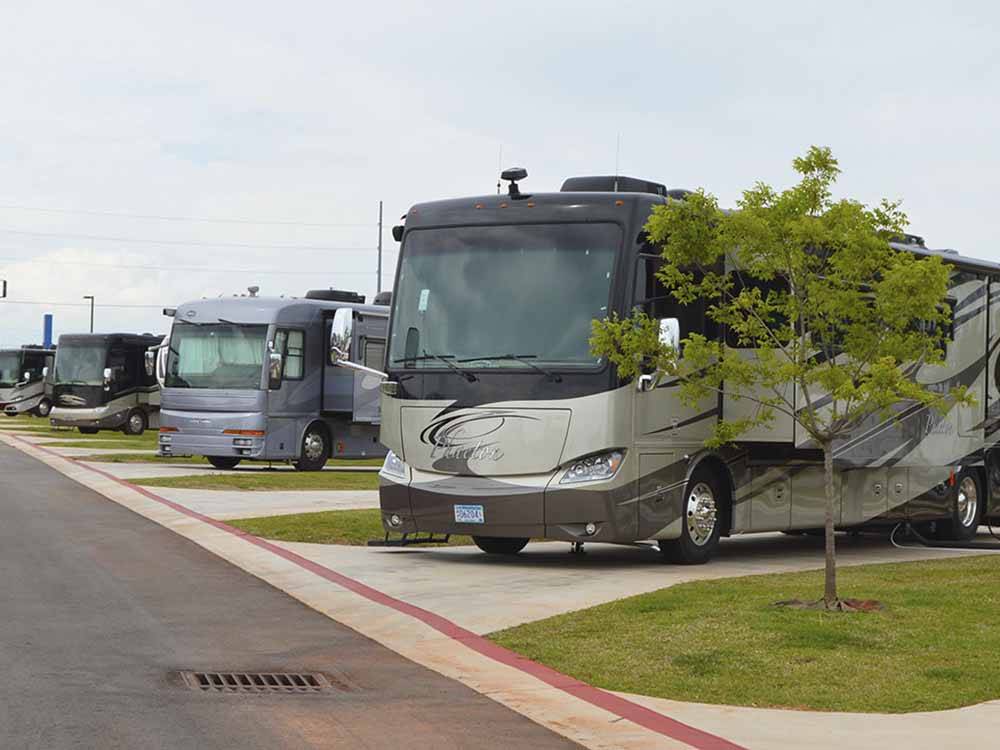 A row of paved RV sites at ROADRUNNER RV PARK