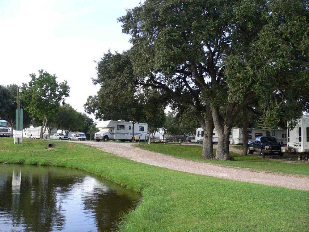 A gravel road leading to the RV sites at SCHULENBURG RV PARK