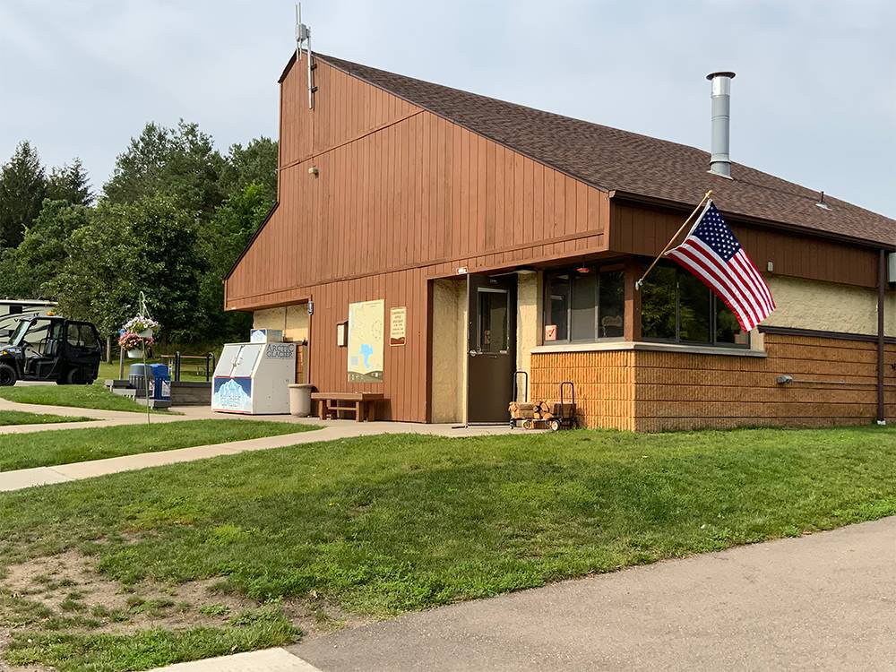 Exterior of the office with an American flag at Lebanon Hills Campground