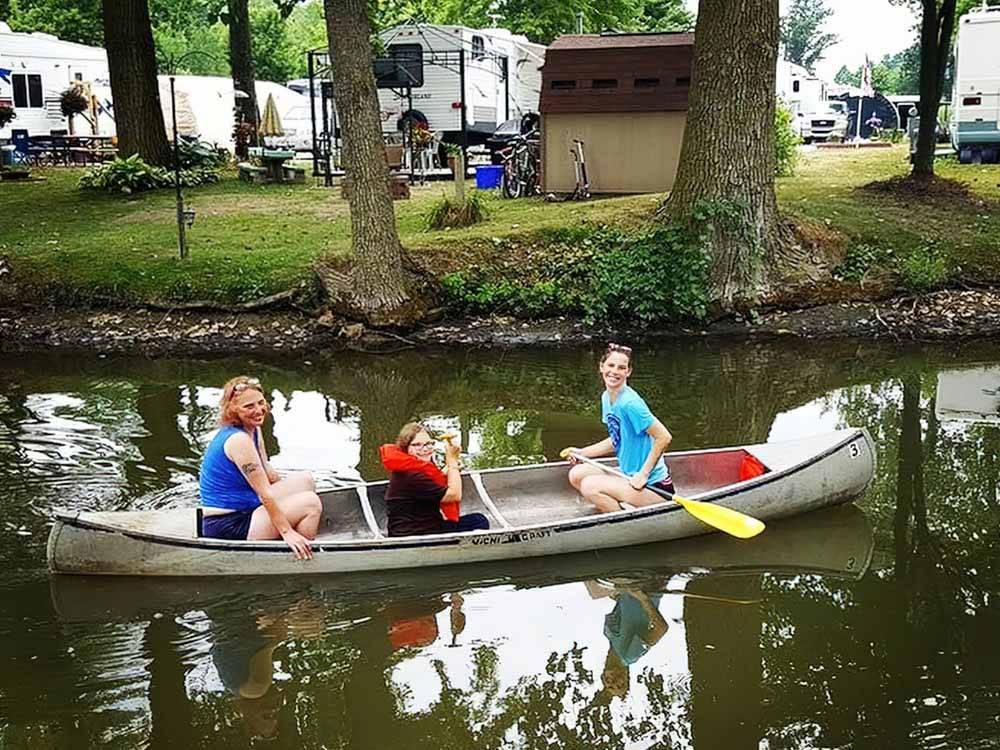A family in a metal canoe at CAMP LORD WILLING RV PARK & CAMPGROUND