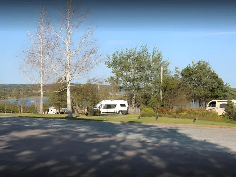 Parked RV's near the lake at site Lunenburg RV Park and Campground