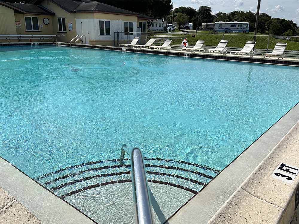 The swimming pool with lounge chairs at LELYNN RV RESORT