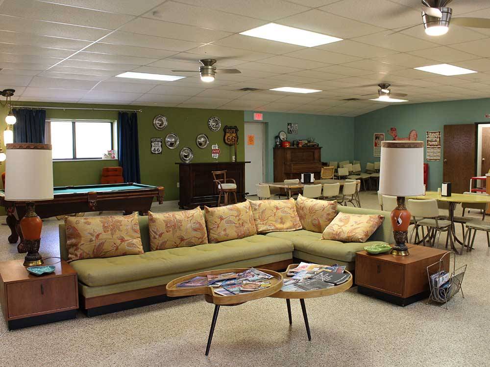 A lounge-area with l-shaped sofa set and 60s-style coffee table at ELK CREEK RV PARK