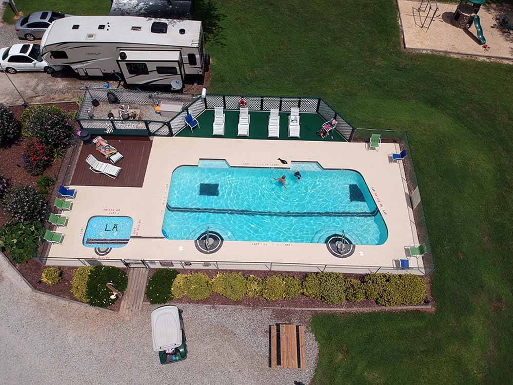An aerial view of an RV shaped pool at LEISURE ACRES CAMPGROUND
