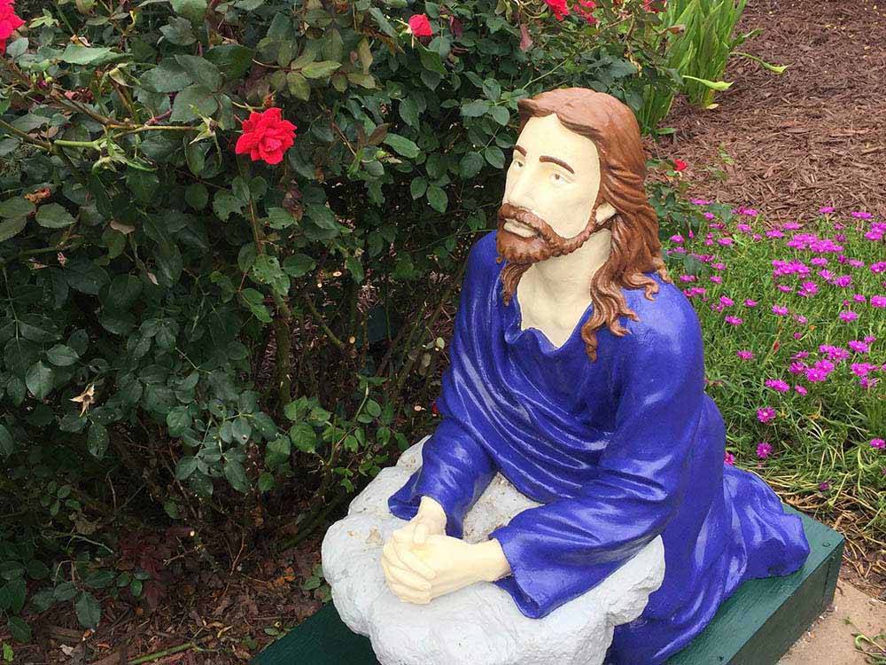 A statue of Jesus kneeling at LEISURE ACRES CAMPGROUND