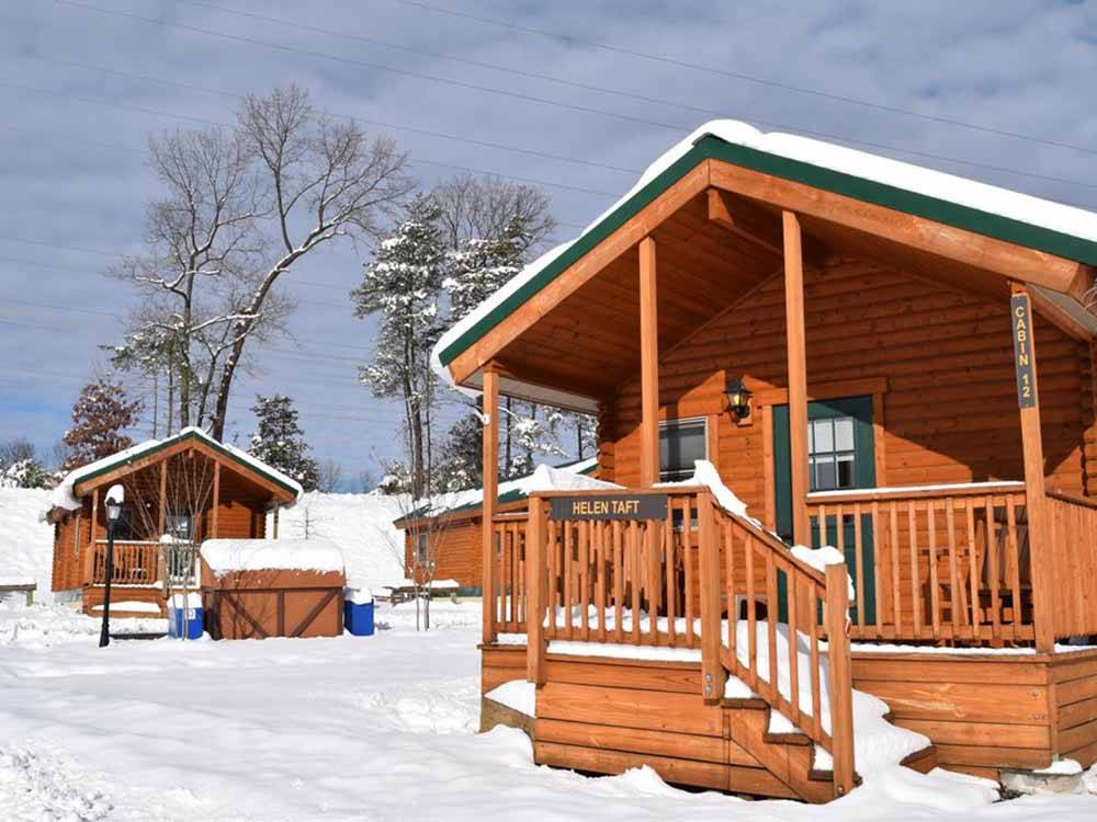 The rustic rental cabins in the snow at CHERRY HILL PARK