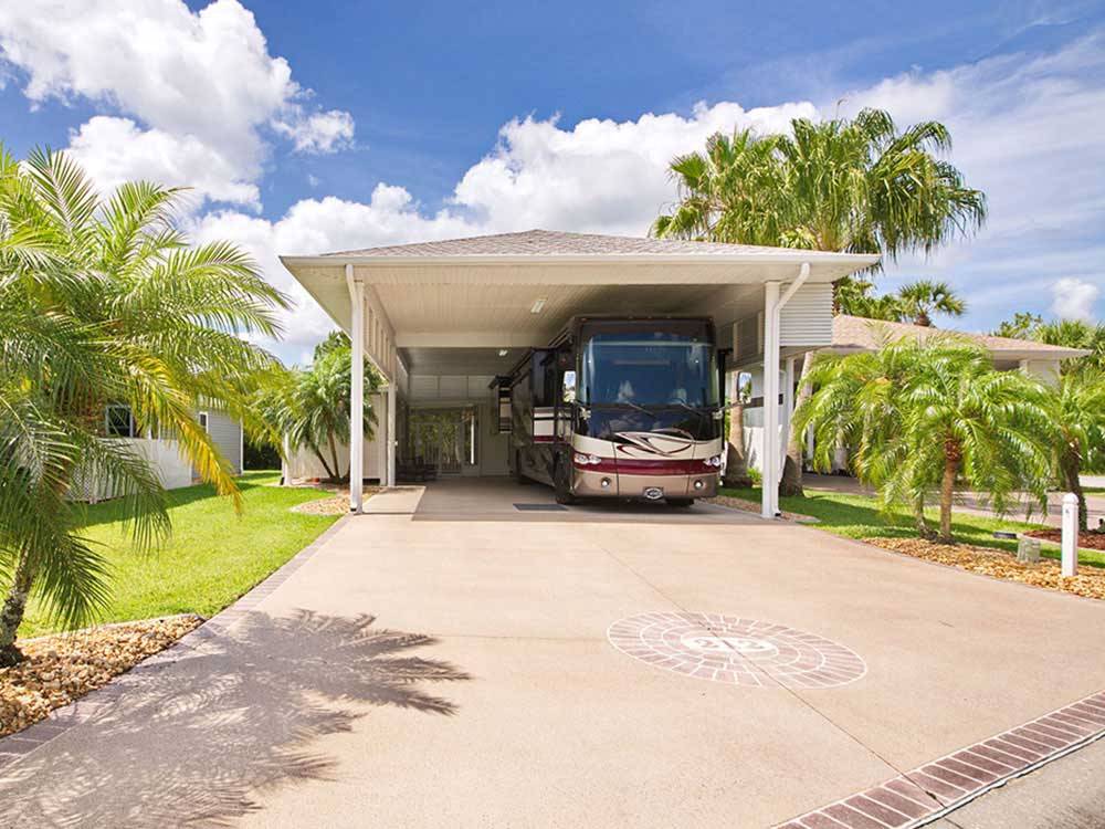 A motorhome in a covered RV site at THE GREAT OUTDOORS RV NATURE & GOLF RESORT