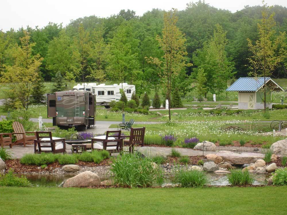 Outdoor seating with RVs in distance at INDIGO BLUFFS RV PARK AND RESORT