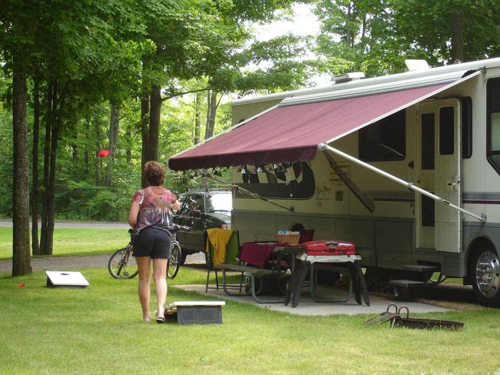 Guest enjoying time outside her RV at INDIGO BLUFFS RV PARK AND RESORT