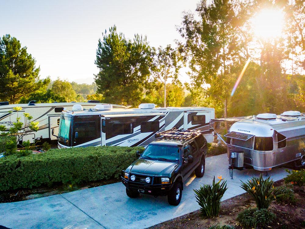 A SUV and Airstream parked in a paved site at ESCONDIDO RV RESORT