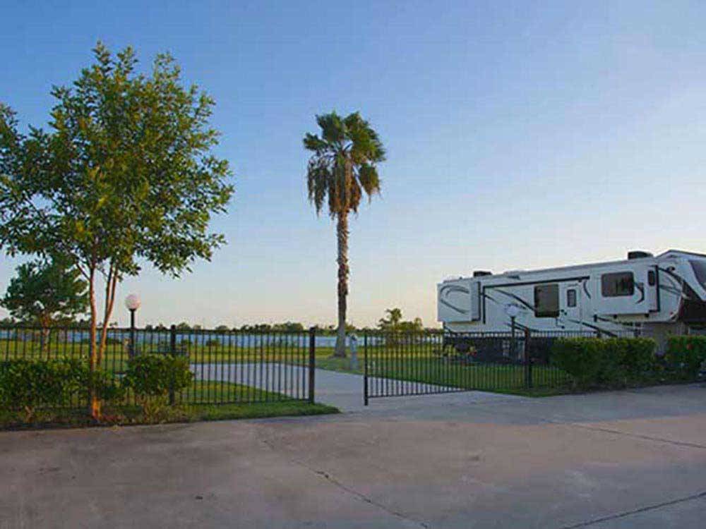 A gated paved back in RV site overlooking the water at HOUSTON EAST RV RESORT