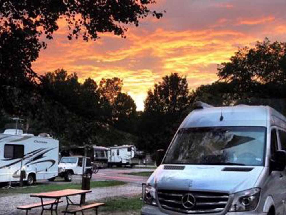 RVs on-site with beautiful sunset in distance at MEMPHIS GRACELAND RV PARK & CAMPGROUND