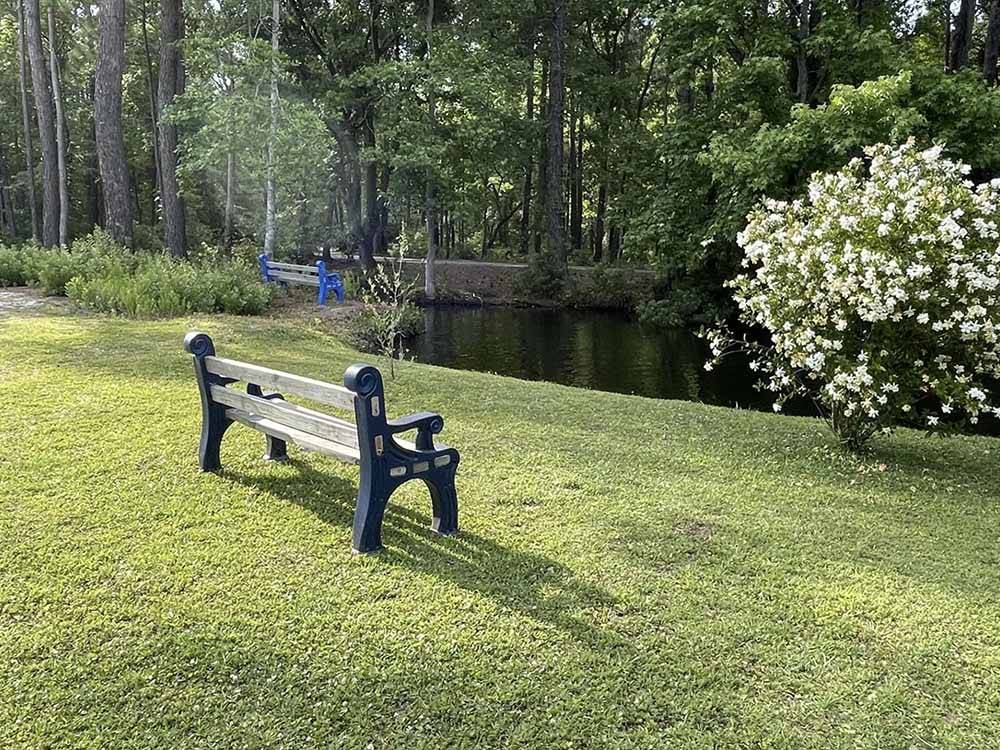 A park bench overlooking the lake at LAKE AIRE RV PARK & CAMPGROUND