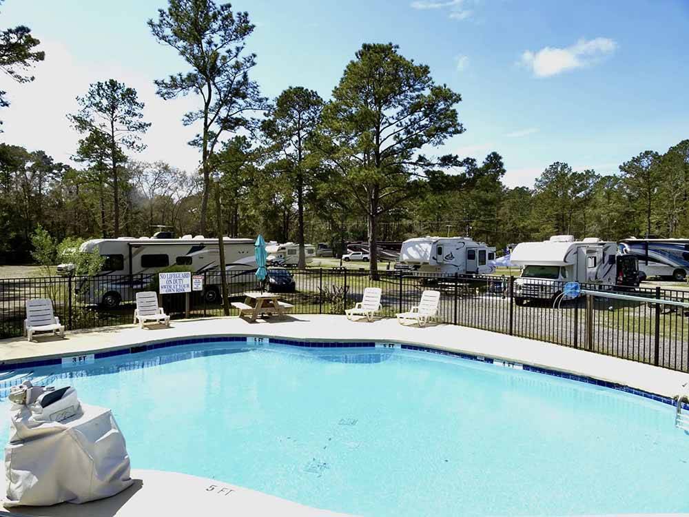 The swimming pool with lounge chairs at LAKE AIRE RV PARK & CAMPGROUND