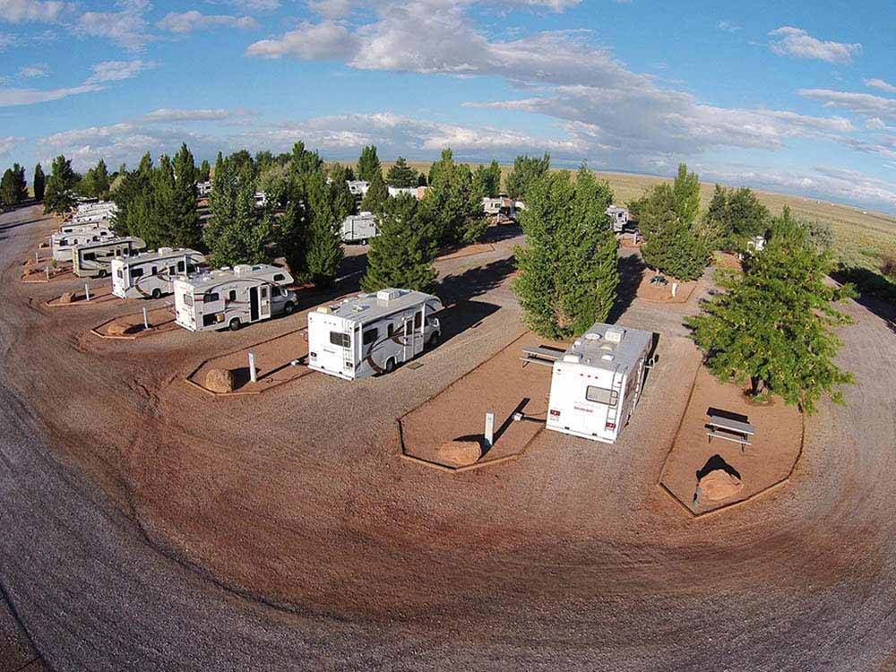 A row of gravel sites with benches at METEOR CRATER RV PARK