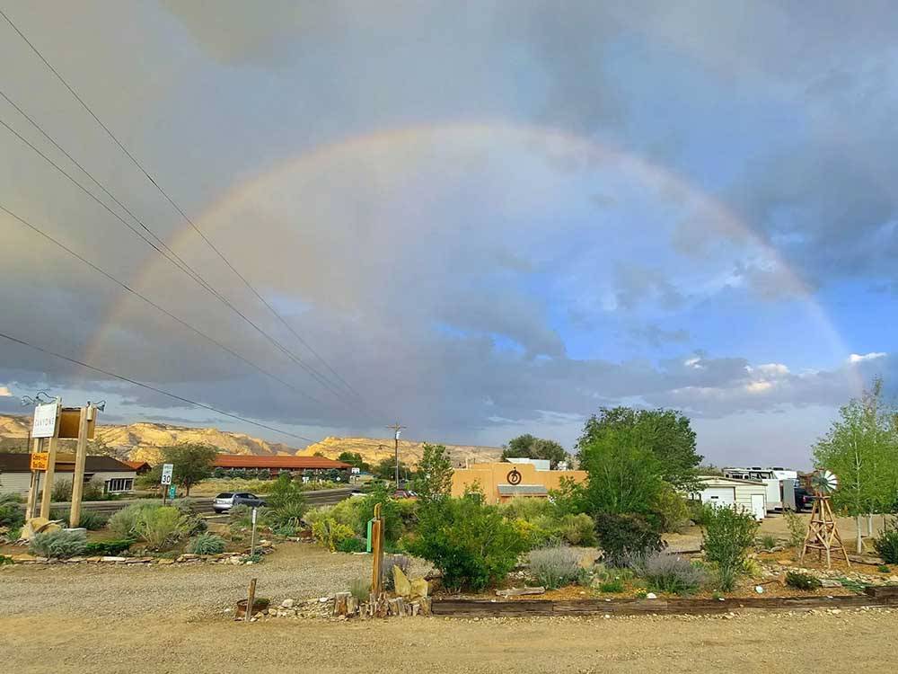 A rainbow forms in the sky at CANYONS OF ESCALANTE RV PARK