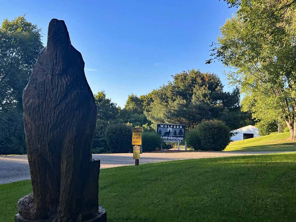 A wooden statue of a bear at WOLFIES CAMPGROUND