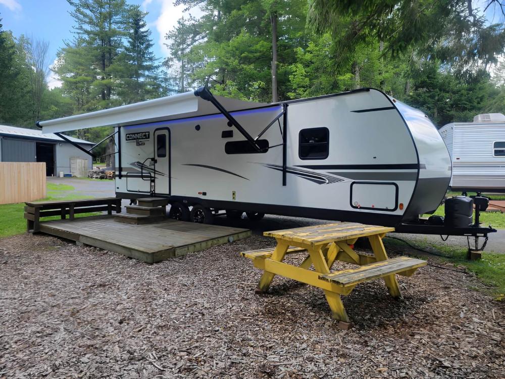 Parked trailer with patio area at Seven Mountains Campground & Cabins
