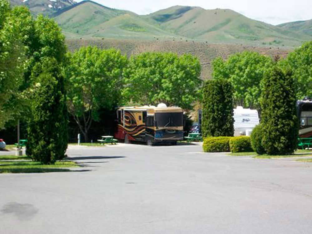 RV in site with hills in the background at COWBOY RV PARK
